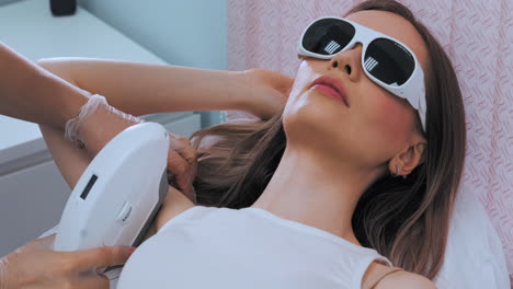 Cosmetologist-does-laser-hair-removal-of-armpits-of-patient.-Epilation-procedure.-Cosmetologist-does-laser-hair-removal-of-the-armpits-of-the-patient.-Epilation